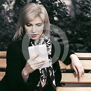 Young fashion blond business woman using digital tablet computer