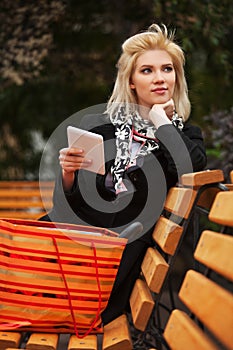 Young fashion blond business woman using digital tablet computer