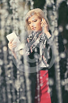 Young fashion blond business woman using digital tablet computer