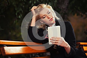 Young fashion blond business woman using digital tablet computer