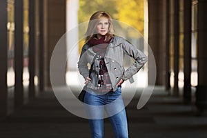 Young fashion blonde woman in checked plaid blazer and snood scarf