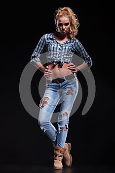 Young fashion blonde woman with hands on hips