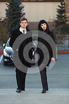 Young fashion business couple on city street