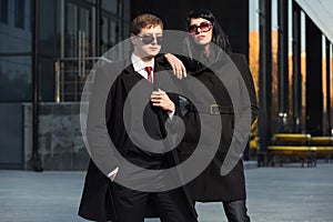 Young fashion business couple on city street