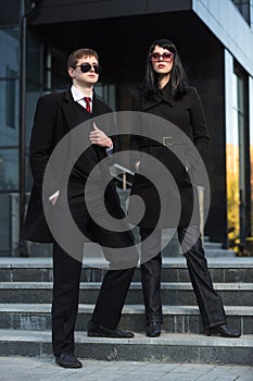 Young fashion business couple on city street