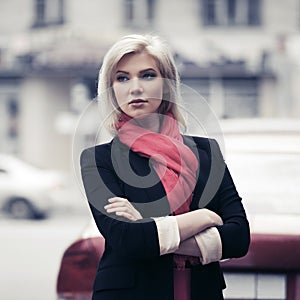 Young fashion business woman walking in city street