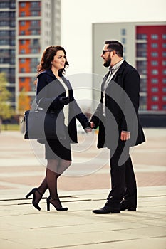 Young fashion couple in love walking on city street