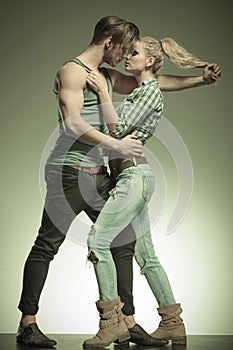 Young fashion couple, man pulling woman's hair
