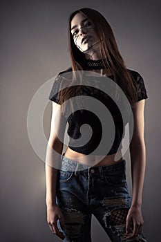 Young fashion cyberpunk girl cut out on gray background