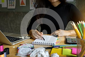 young fashion designer work with fabric cloth on the table