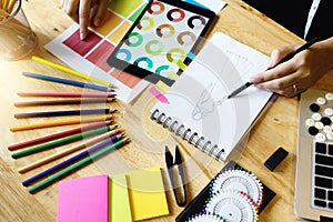 young fashion designer work with fabric cloth on the table