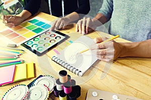 young fashion designer work with fabric cloth on the table