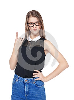 Young fashion girl in jeans with horn gesture isolated