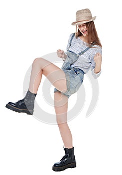 Young fashion girl in jeans overalls with yes gesture isolated