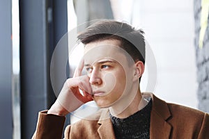 Young fashion guy portrait with hand on face