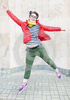 Young fashion hipster woman with colorful hair jumping