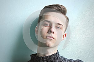 Young fashion man portrait on a blue background