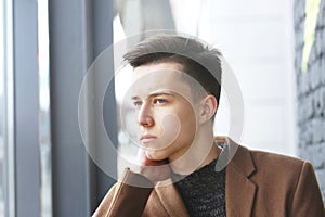 Young fashion man portrait with hand on face