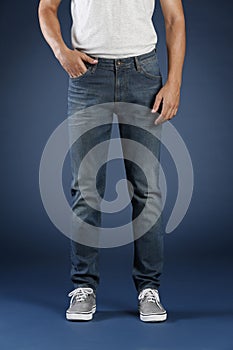 Young fashion man`s legs in jeans