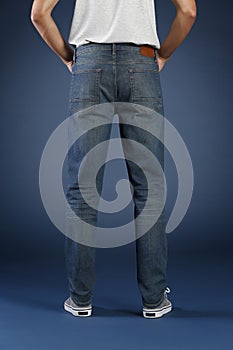 Young fashion man`s legs in jeans