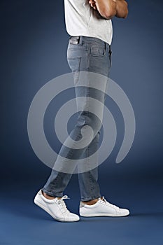 Young fashion man`s legs in jeans