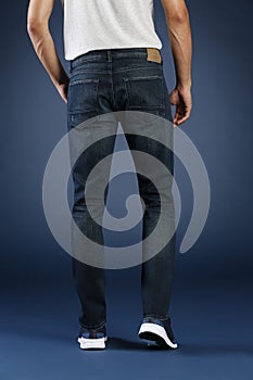 Young fashion man`s legs in jeans