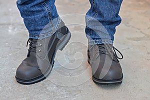 Young fashion man`s legs in jeans and boots