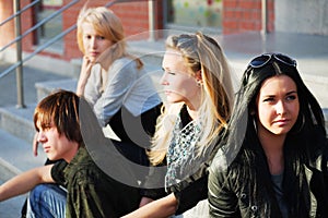 Young fashion teens sitting on steps