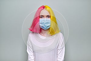 Young fashion trendy hipster woman in medical protective mask