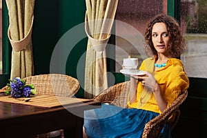 Young fashion woman drinking tea at restaurant