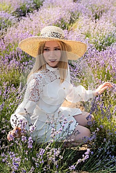 Young and fashion woman in hat posing at lavender field