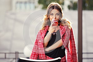 Young fashion woman in red tweed jacket and skirt suit