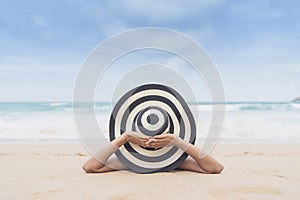 Young fashion woman relax on the beach. Happy island lifestyle. White sand, blue cloudy sky and crystal sea of tropical beach