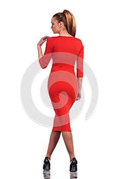 Young fashion woman standing with her legs crossed
