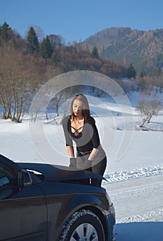 young fashion woman trying to fix the car