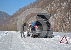 Young fashion woman trying to fix the car