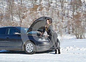 Young fashion woman trying to fix the car