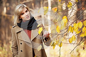 Young fashion woman walking in autumn forest