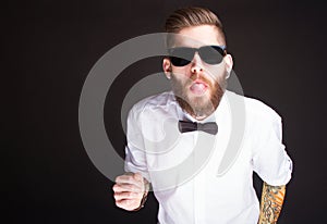 Young fashionable hipster man in white shirt