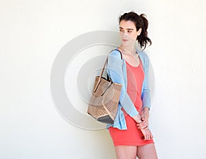 Young fashionable lady glancing behind