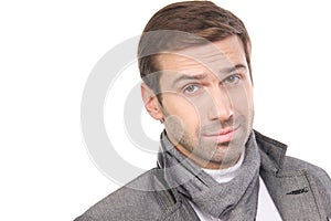 Young fashionable man wearing a scarf and gray clothes