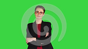 Young fashionable woman with folded hand on a Green Screen, Chroma Key.