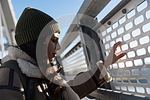 Young fashionable woman in ghetto urban street style wardrobe on the street. Different look female with cool attitude outdoor