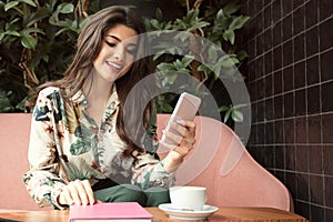 Young fashionable woman using mobile phone