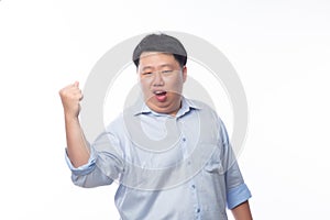 Young Fat Asian business man raising his fists with funny face isolated on white background.