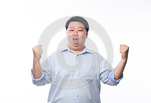 Young Fat Asian business man raising his fists with funny face isolated on white background.