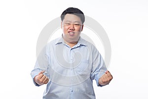 Young Fat Asian business man raising his fists with funny face