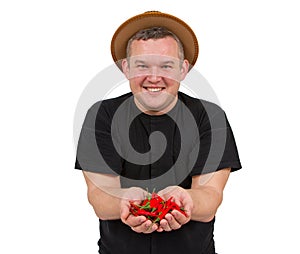 Young fat man with chili in his hands.