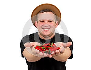 Young fat man with chili in his hands.