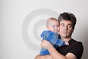 Young father with a baby. Selective focus. Cute dad is played with a baby